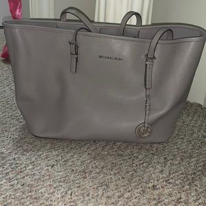Gray Michael Kors purse.